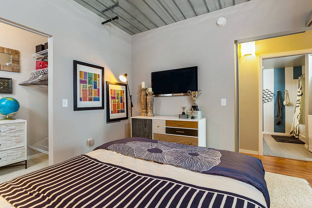 a bedroom with a bed and a tv at Ann Arbor City Club, Ann Arbor, MI